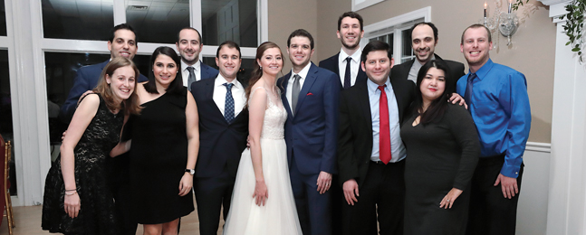 Bride and groom surrounded by wedding guests